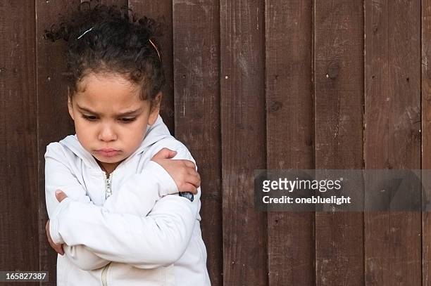 young little girl with arms crossed and sad - tantrum stock pictures, royalty-free photos & images