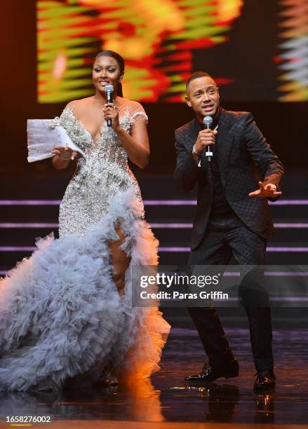Co-hosts Osas Ighodaro and Terrence "Terrence J " Jenkins speak onstage during The 16th Headies Awards at Cobb Energy Performing Arts Centre on...