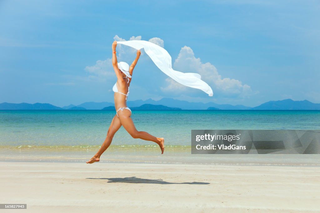 Beauty girl jumping on sea background