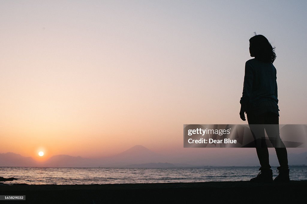 Sunset Silhouette of a woman at Enoshima, Japan