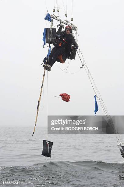 Matt Silver-Vallance drops some excess material as he flies above Table Bay, with some of his support crew in boats from Nelson Mandela's apartheid...