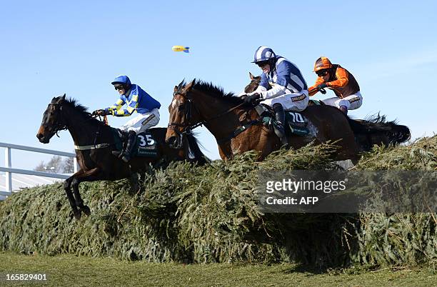 Winner Auroras Encore ridden by Ryan Mania and Teaforthree ridden by Nick Scholfield take a jump during the Grand National horse race at Aintree...