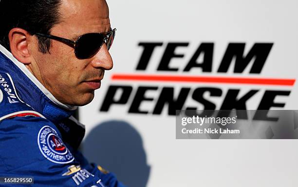 Helio Castroneves of Brazil, driver of the AAA Insurance Team Penske sits on pit wall after practice for the Honda Indy Grand Prix of Alabama at...