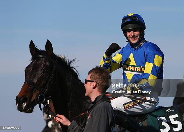 Auroras Encore ridden by Ryan Mania celebrates winning the John Smiths Grand National at Aintree Racecourse on April 6, 2013 in Liverpool, England.