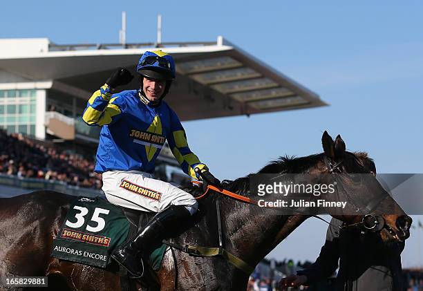 Auroras Encore ridden by Ryan Mania celebrates winning the John Smiths Grand National at Aintree Racecourse on April 6, 2013 in Liverpool, England.