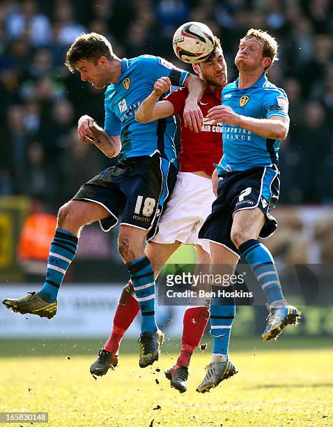Johnnie Jackson of Charlton battles for and aerial ball with Michael Tonge and Paul Green of Leeds during the npower Championship match between...