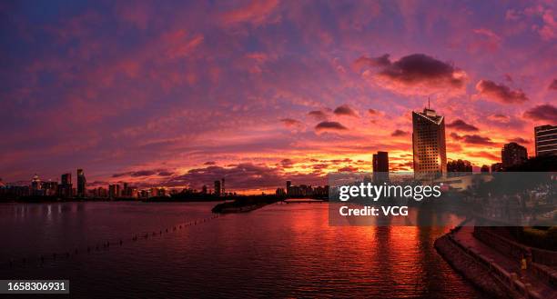 Crimson clouds are seen in the sky over buildings as Typhoon Haikui approaches on September 3, 2023 in Xiamen, Fujian Province of China.