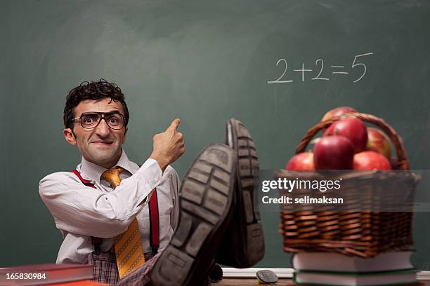 nerd teacher in classroom with basket of apples - crazy professor stockfoto's en -beelden