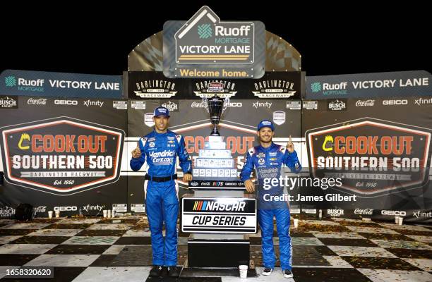 Kyle Larson, driver of the HendrickCars.com Chevrolet, and crew chief Cliff Daniels celebrate in victory lane after winning the NASCAR Cup Series...