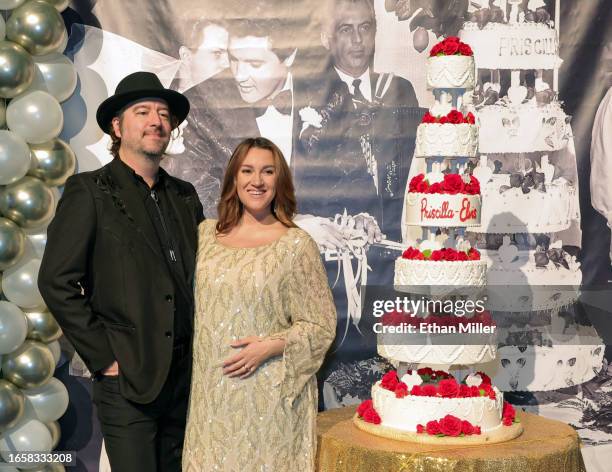 Andrew Miller and Tiffany Miller, both of Nevada, pose with a six-tiered cake that was inspired by Elvis and Priscilla Presley's 1967 wedding cake,...