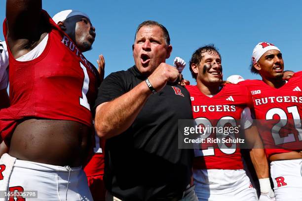 Head coach Greg Schiano of the Rutgers Scarlet Knights celebrates with his team after a 24-7 victory over the Northwestern Wildcats in a college...