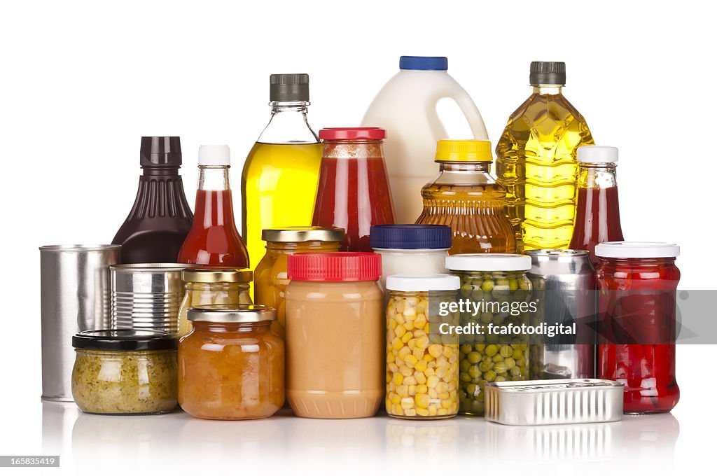 Large group of canned food sitting on white backdrop