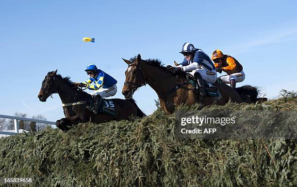 Winner Auroras Encore ridden by Ryan Mania and Teaforthree ridden by Nick Scholfield jump the last fence during the Grand National horse race at...