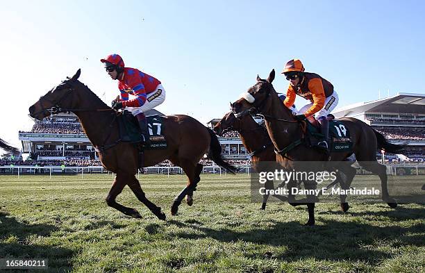 Horse and riders run past the stands during the Grand National race during Grand National Day at Aintree on April 6, 2013 in Liverpool, England....