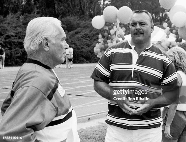 Actor Ted Knight speaks with former Chicago Bears Linebacker Dick Butkus during filming of Star Games Challenge at the University California Santa...