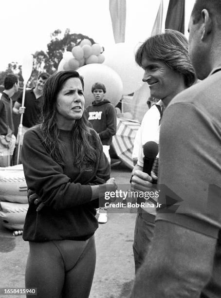 Actress Patti Davis talks with Olympian Bruce Jenner and former Chicago Bears great Dick Butkus during filming of Star Games Challenge at the...