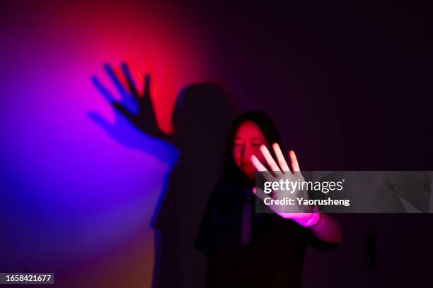 beautiful asian woman lit with neon lights - fluorescent light stock pictures, royalty-free photos & images