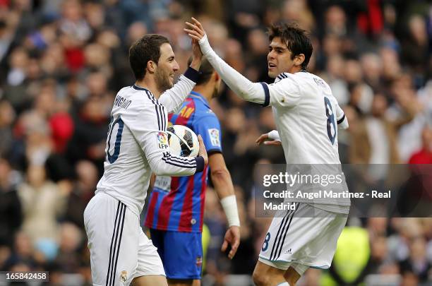 Gonzalo Higuain of Real Madrid celebrates with Kaka after scoring the equalising goal during the La Liga match between Real Madrid and Levante at...