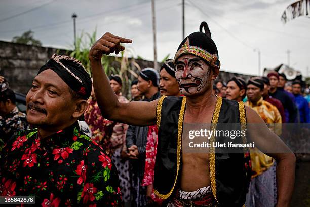 Javanese men wearing traditional costume parade during the Cembengan ritual 'Manten Tebu' on April 6, 2013 in Yogyakarta, Indonesia. The Cembengan...