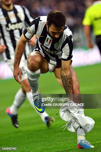 Juventus' forward of Montenegro Mirko Vucinic takes off his short as he celebrates after scoring a penalty during the Serie A football match between...