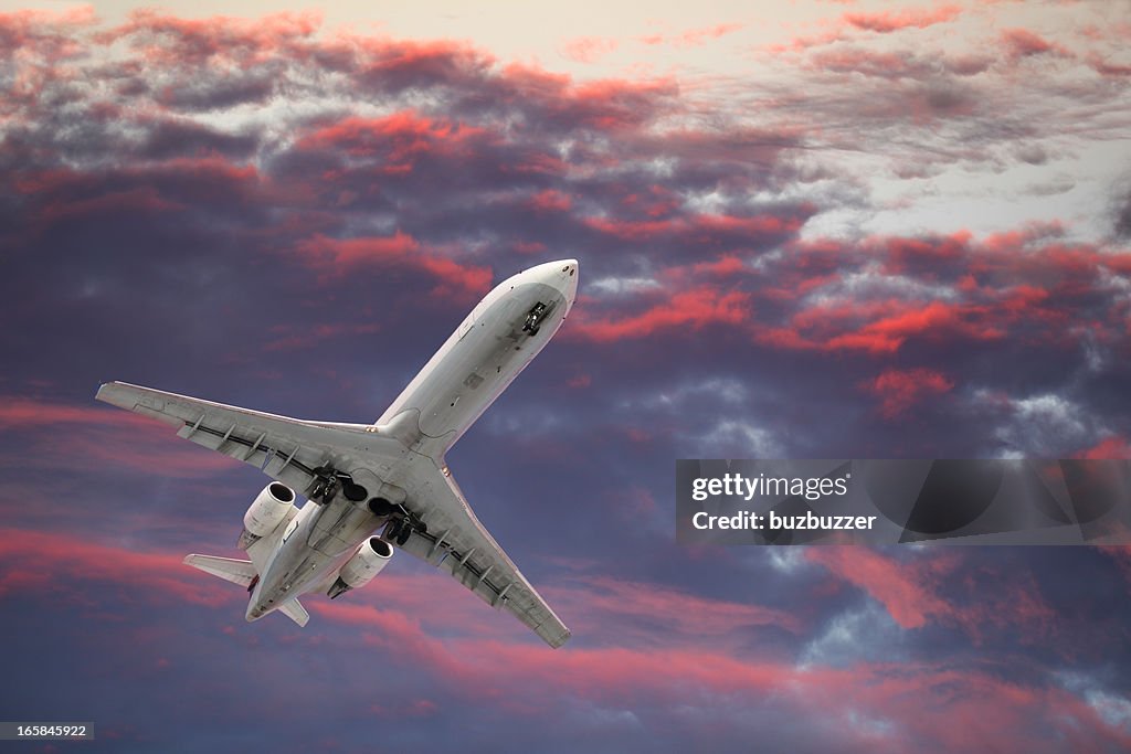 Private Jet Airplane Flying in a Colorful Sky