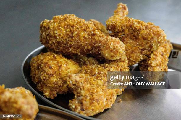 In this photo taken on June 13 fried chicken is seen on a plate after it was cooked by a robot, at a Robert Chicken restaurant in Seoul. In...