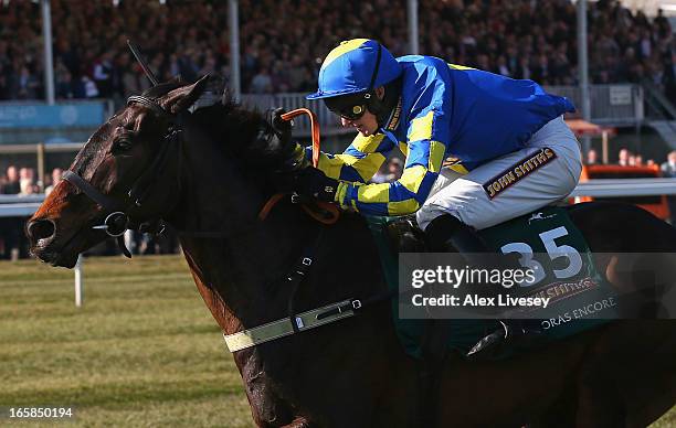 Ryan Mania riding Auroras Encore clears the last fence on their way to victory in the John Smiths Grand National at Aintree Racecourse on April 6,...