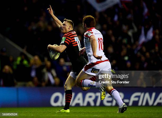 Chris Ashton of Saracens outpaces Paddy Jackson of Ulster to score his team's second try during the Heineken Cup quarter final match between Saracens...