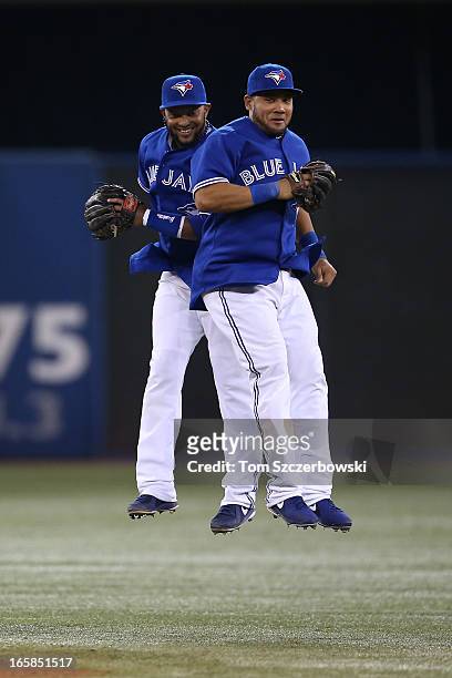 Emilio Bonifacio of the Toronto Blue Jays celebrates with Melky Cabrera during MLB game action after defeating the Boston Red Sox on April 6, 2013 at...