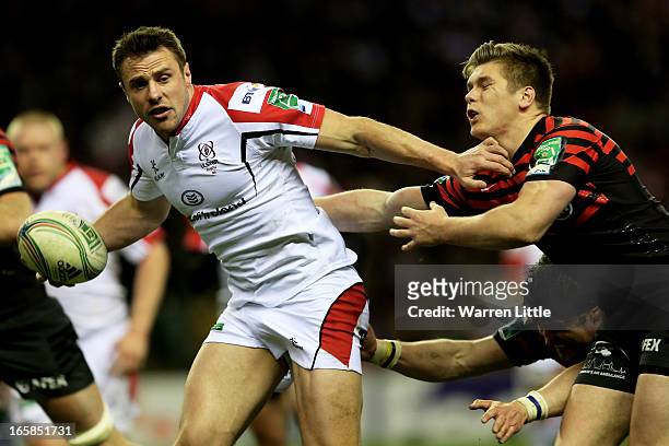 Tommy Bowe of Ulster fends off Owen Farrell and Ernst Joubert of Saracens during the Heineken Cup quarter final match between Saracens and Ulster at...