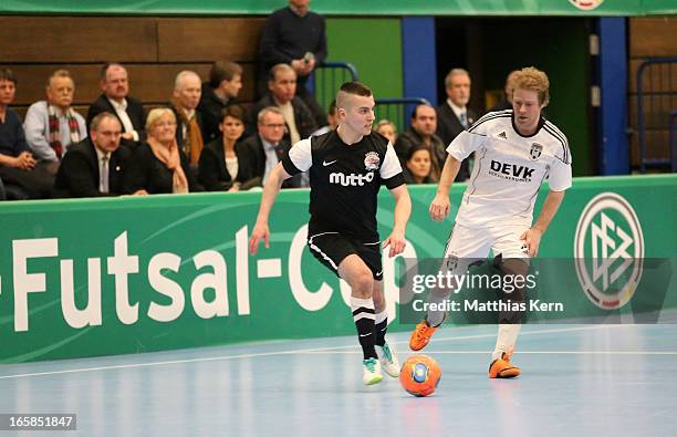 Florian Dondorf of Muenster battles for the ball with Carlos Rafael Ferreira Monteiro of Hamburg during the DFB Futsal Cup final match between...