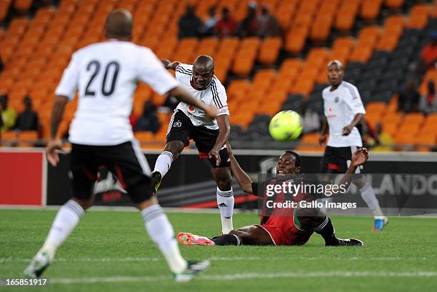 Khethowakhe Masuku of Pirates shooting past Samson Chilupe of Zanaco FC during the CAF Confedaration Cup match between Orlando Pirates and Zanaco at...