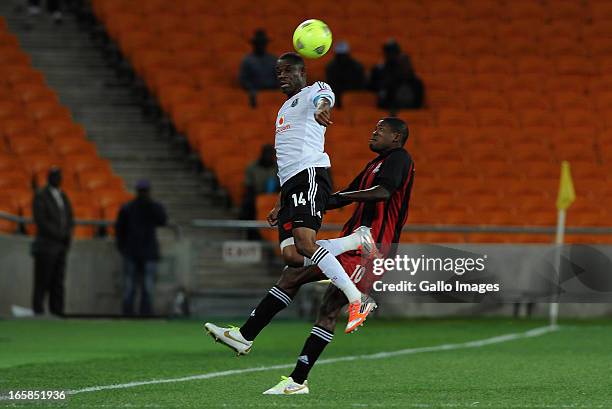 Lucky Lekgwathi of Pirates battling for the ball with Dawies Mwape of Zanaco FC during the CAF Confedaration Cup match between Orlando Pirates and...