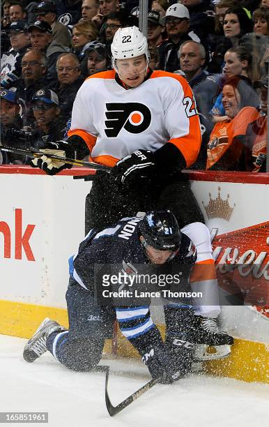 Luke Schenn of the Philadelphia Flyers gets pinned to the boards by a fallen Aaron Gagnon of the Winnipeg Jets during first period action at the MTS...