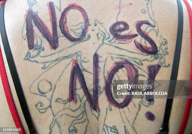 View of a tattoo of a woman writen on top "No is no!"as she attends the "Putas" march in the streets of Medellin, Antioquia department, Colombia on...