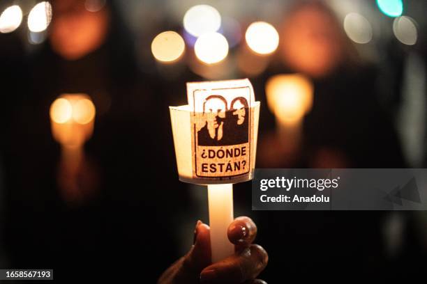 Thousands of women light candles in front of the La Moneda presidential palace, during the commemoration of the 50th anniversary of the military coup...