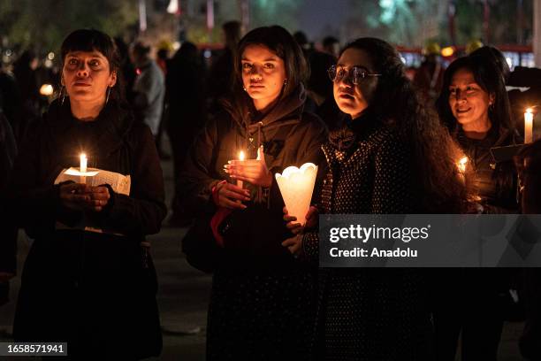 Thousands of women light candles in front of the La Moneda presidential palace, during the commemoration of the 50th anniversary of the military coup...