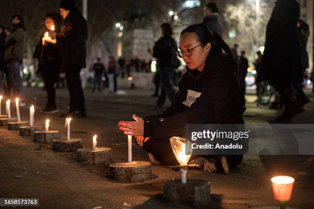 Thousands of women light candles in front of the La Moneda presidential palace, during the commemoration of the 50th anniversary of the military coup...