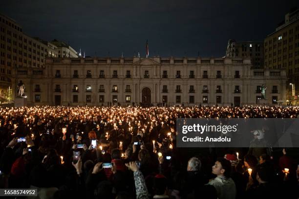 Thousands of women light candles in front of the La Moneda presidential palace, during the commemoration of the 50th anniversary of the military coup...