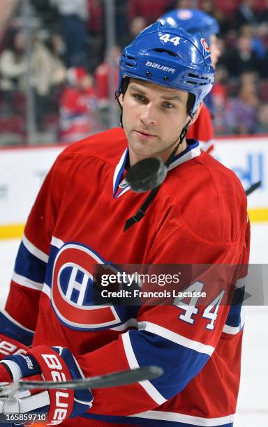 Davis Drewiske of the Montreal Canadiens juggles a puck during the warm up period prior to facing the Boston Bruins on April 6, 2013 at the Bell...