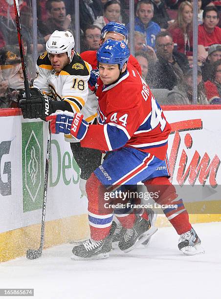 Davis Drewiske of the Montreal Canadiens checks Nathan Horton of the Boston Bruins in the boards during the NHL game on April 6, 2013 at the Bell...