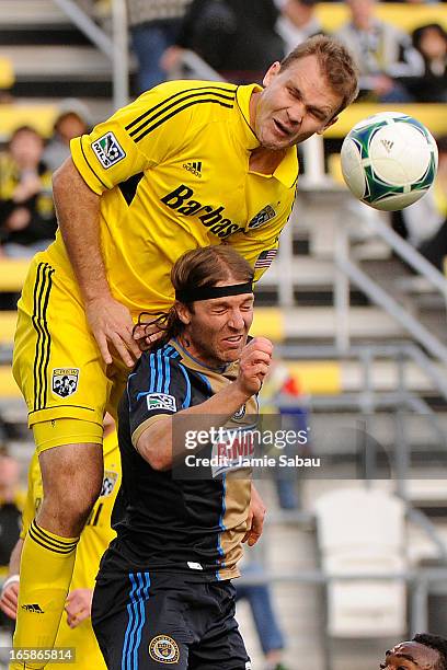 Chad Marshall of the Columbus Crew goes over the top of Jeff Parke of the Philadelphia Union to head the ball in the second half on April 6, 2013 at...