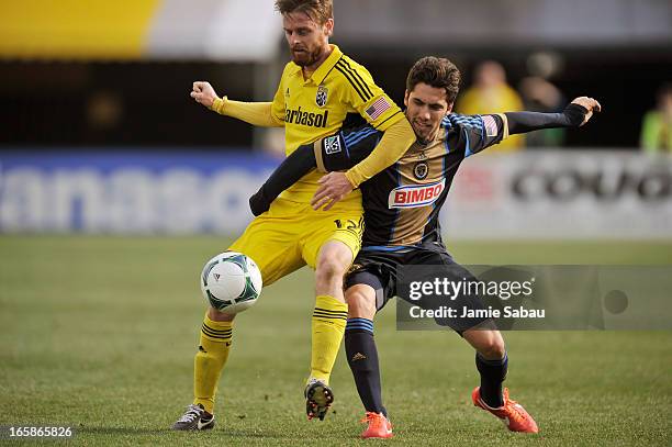 Eddie Gaven of the Columbus Crew and Gabriel Farfan of Philadelphia Union battle for control of the ball in the first half on April 6, 2013 at Crew...