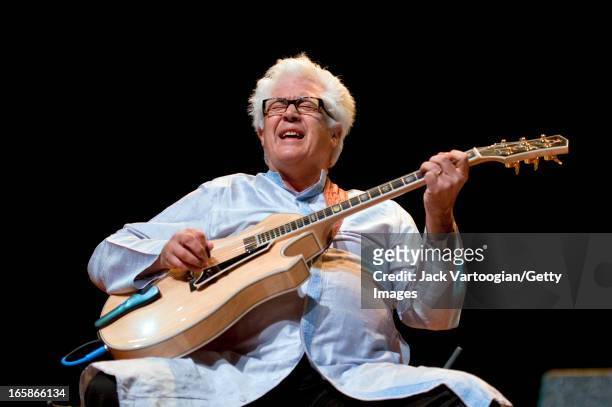 American jazz musician Larry Coryell plays guitar as he leads his band, Bombay Jazz, at a World Music Institute concert at New York University's...