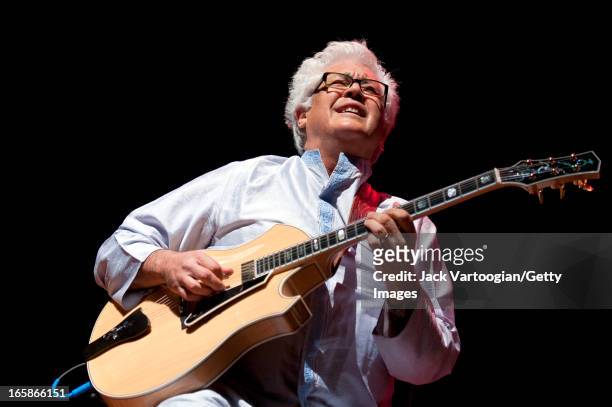 American jazz musician Larry Coryell plays guitar as he leads his band, Bombay Jazz, at a World Music Institute concert at New York University's...