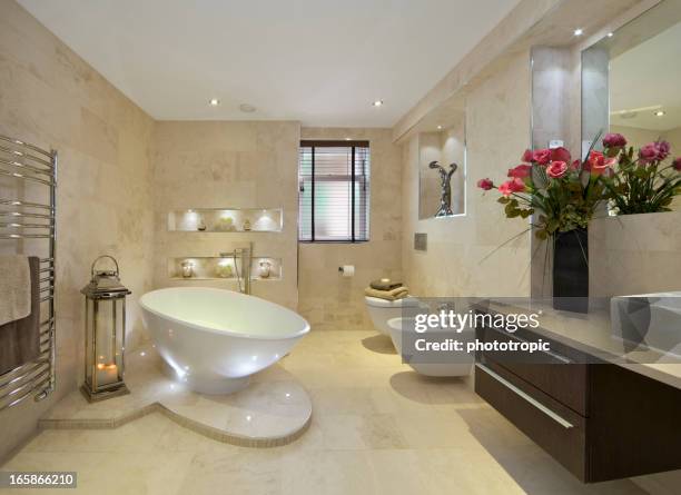 elegant bathroom with flowers - new bathtub stock pictures, royalty-free photos & images