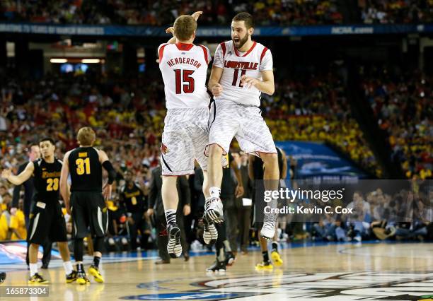 Tim Henderson and Luke Hancock of the Louisville Cardinals celebrate late in the second half while taking on the Wichita State Shockers during the...