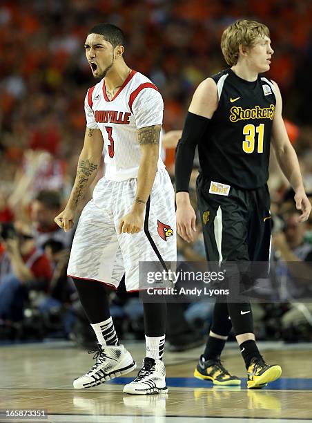 Peyton Siva of the Louisville Cardinals reacts in the second half against Ron Baker of the Wichita State Shockers during the 2013 NCAA Men's Final...