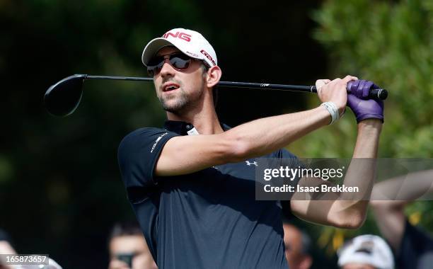 Olympic Gold Medalist Michael Phelps hits a tee shot during ARIA Resort & Casino's Michael Jordan Celebrity Invitational golf tournament at Shadow...