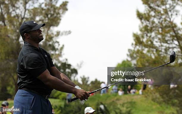 Dwight Freeney hits a tee shot during ARIA Resort & Casino's Michael Jordan Celebrity Invitational golf tournament at Shadow Creek on April 6, 2013...